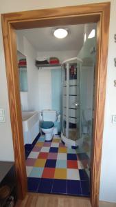 a bathroom with two toilets and a colorful floor at Apto. residencial en Torremolinos con piscina. in Torremolinos