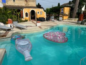 a swimming pool with a bunch of buoys in the water at Le Clos de L'Isle in Arles