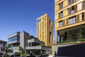 a tall yellow building next to two other buildings at Ultra Lux Residence Flat-Great LocationB1 in Istanbul