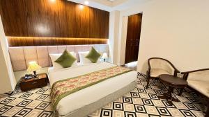 a hotel room with a bed and a chair at IP Royal Hotel - Couple Friendly Near Yamuna Sports Complex, Karkardooma New Delhi in New Delhi