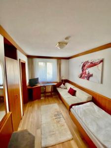 a living room with two couches and a desk at Hotel Krone in Neuenburg am Rhein