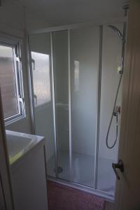 a bathroom with a shower and a sink at KD 883 - Vakantiepark Kijkduin in The Hague