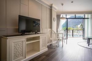a living room with a flat screen tv on a entertainment center at Heaven View Krabi SHA in Ao Nam Mao