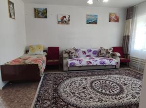 a living room with a couch and a bed at Villa Valentina Issyk-Kul in Grigor'yevka