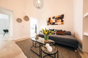 a living room with a couch and a table at HelloApulia - La Terrazza di Don Nino in Polignano a Mare