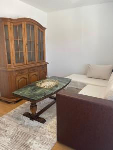 a room with a table and a bed and a cabinet at Apartment SunLight in Visoko