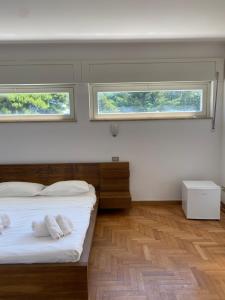 a bedroom with two beds and two windows at Domus in Terracina