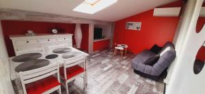 Piccola camera con tavolo, sedia e pareti rosse di Appartement studio avec terrasse privatisée a Marmande