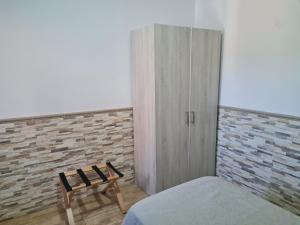 a bedroom with a bed and a wardrobe and a chair at Hotel Balneario Fuentes del Trampal in Carmonita +38 photos