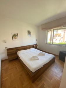 a bedroom with a bed with two towels on it at Domus in Terracina