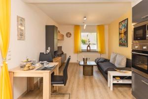 a living room with a couch and a table at Ferienwohnung Schwallmann in Wilnsdorf