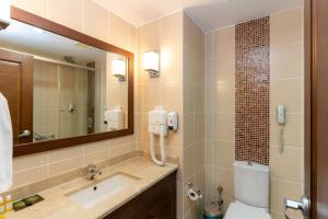 a bathroom with a sink and a toilet and a mirror at Latanya Park Resort in Yaliciftlik +26 photos