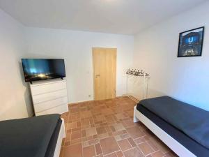 a bedroom with a bed and a flat screen tv at Spacious Apartment in Ibbenbüren in Ibbenbüren