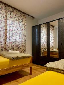 a room with two beds and a mirror at Apartment SunLight in Visoko