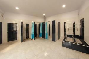 a large bathroom with blue shower stalls in it at Vanadzor Armenia Hotel in Vanadzor