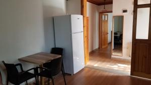 a kitchen with a small table and a refrigerator at Huge Evleri 3 in Marmaris