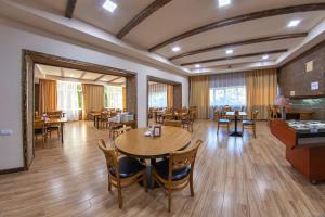 een eetkamer met houten tafels en stoelen bij Vanadzor Armenia Hotel in Vanadzor