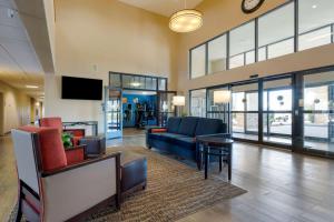 a lobby with a couch and chairs and a tv at Comfort Inn Camp Verde I-17 in Camp Verde