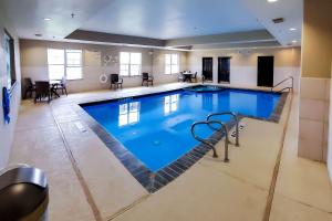 a large swimming pool in a hotel room at Comfort Suites Tomball Medical Center in Tomball