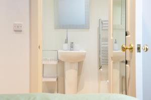 a bathroom with a sink and a mirror at Parade School Guest Rooms in Berwick-Upon-Tweed +57 photos