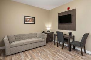 a living room with a couch and a table at Econo Lodge in Prince George