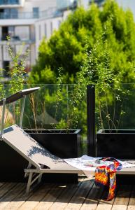 a bed on a balcony with potted plants at Abieshomes Serviced Apartments Schönbrunn in Vienna