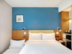 Voodi või voodid majutusasutuse ibis Styles Bogor Pajajaran toas