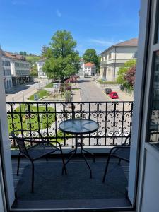 a balcony with a table and a view of a street at Appartment- Suite im Hotel Krone mit Seeblick in Heiden