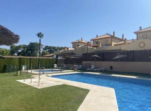 a large swimming pool in front of a house at Villa Dulce Algarve Golf and Beach in Islantilla