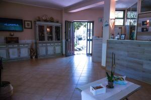 a large room with a kitchen and a lobby at Hotel L'Oleandro in Villasimius