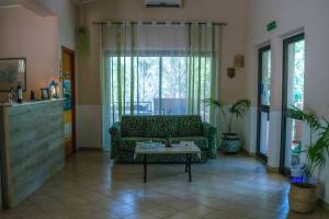 a living room with a couch and a table at Hotel L'Oleandro in Villasimius