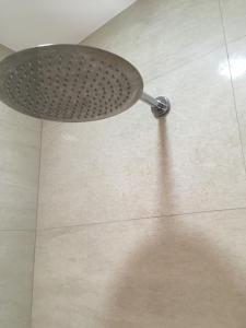 a shower head on top of a tile floor at Villa Rakhimov in Herceg-Novi