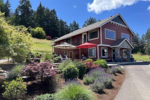 a house with a garden in front of it at Santos Family Farm Retreat in Yamhill