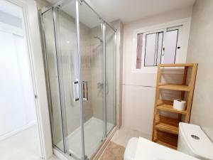 a glass shower in a bathroom with a toilet at Estepona Vistamar 3 bedrooms in Estepona +63 photos