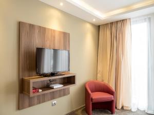 Uma TV ou centro de entretenimento em Hotel Calipso Hotel