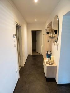 a room with a hallway with a mirror and a sink at Apartment Peskoller in Falzes