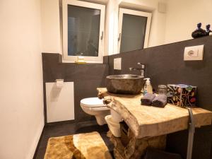 a bathroom with a sink and a toilet at Apartment Peskoller in Falzes