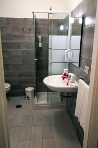 a bathroom with a sink and a shower at Hotel Oleandro in Villasimius