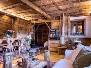 a living room with a glass table in a log cabin at Hotel da Beppe Sello in Cortina dʼAmpezzo