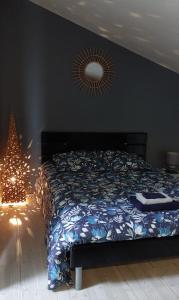 a bedroom with a bed and a christmas tree at Appartement studio avec terrasse privatisée in Marmande