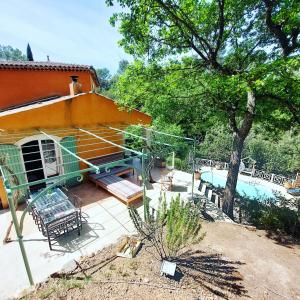 een huis met een patio en een zwembad bij Robin's Lodge in Vidauban