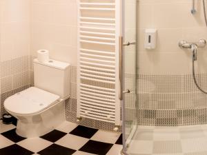 a bathroom with a toilet and a glass shower at Casa Moritz in Braşov