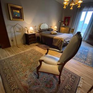 a bedroom with a bed and a chair in it at Bice house in Terni