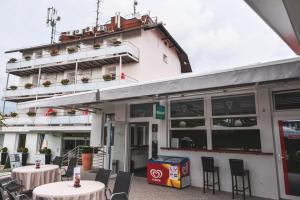 a restaurant with tables and chairs in front of a building at Hotel Bellevue in Kranj