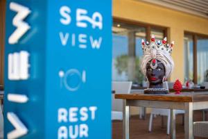 a statue of a woman with a crown on her head at Hotel Riva Del Sole in Cefalù