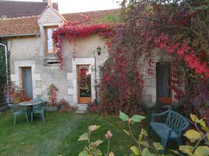 a house with a table and chairs in the yard at Domaine de la Grange aux Dîmes in Feux