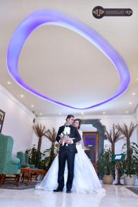 a bride and groom standing in front of a large mirror at Retac El Arish in El Arish