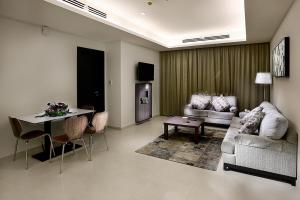 a living room with a couch and a table at لي لي جراند للشقق المخدومة - درجة اقتصادية in Al Hofuf