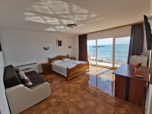 a bedroom with a bed and a view of the ocean at ADONIS Costinesti in Costinesti