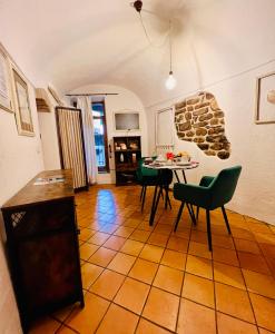 a kitchen and dining room with a table and chairs at Stecadó Casté - Nel centro storico del paese in Dolceacqua
